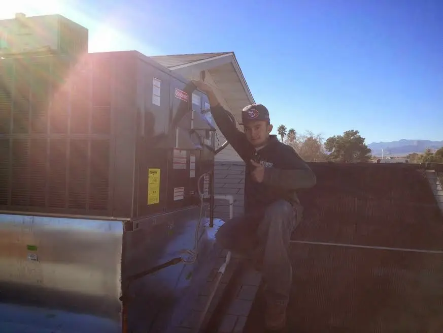 HVAC technician performing HVAC Inspection on a rooftop unit in La Grange Park